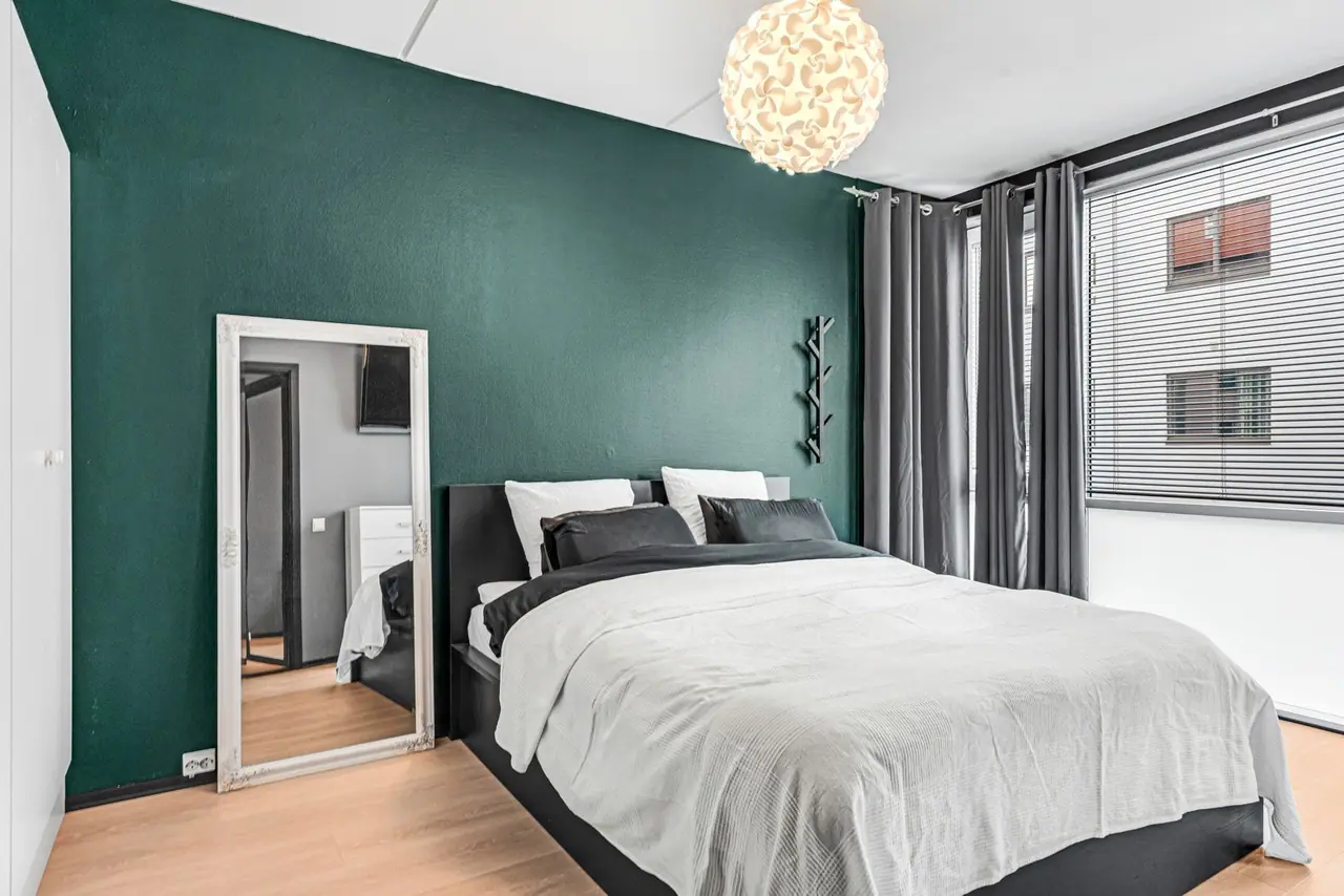 Spacious main bedroom in pleasant colours.